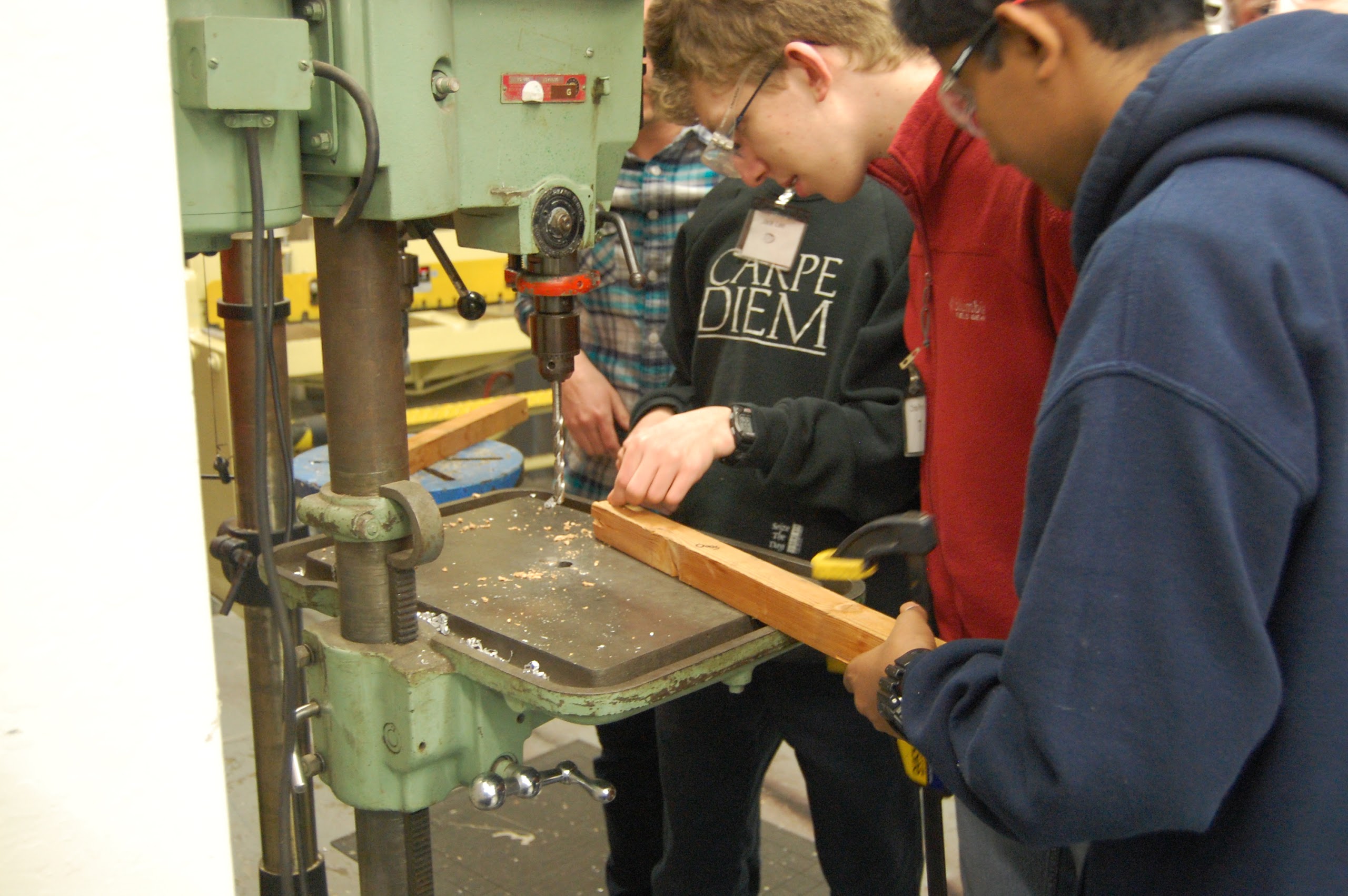 Use the drill press to machine parts for the catcher prototype.