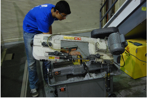 Student cutting the axles for rollers