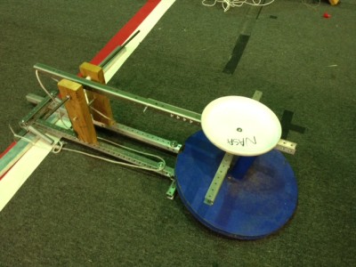 The catapult launcher uses springs assisted by rope and pulleys. The frisbee on the end of the rod helps to hold the ball.