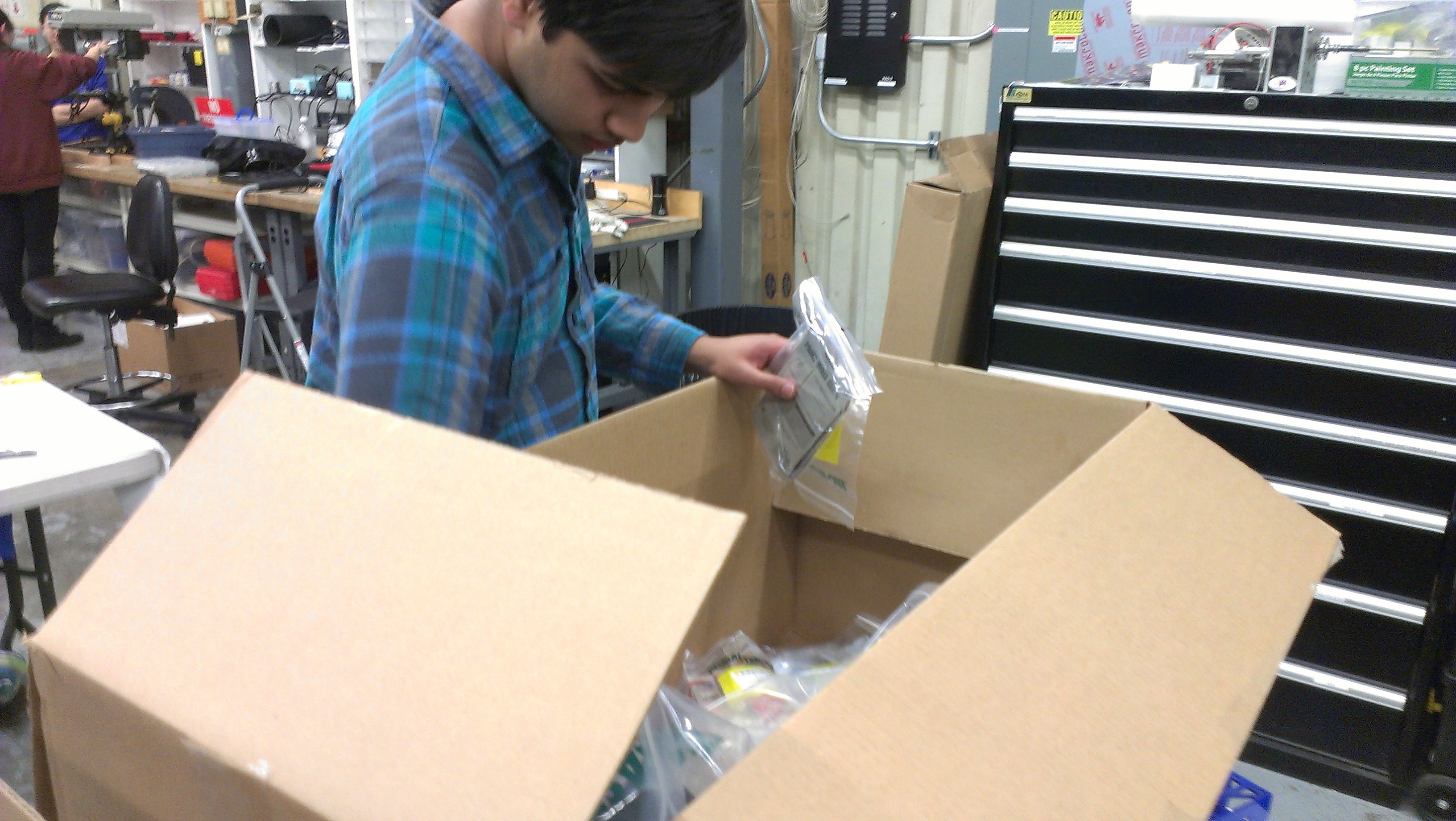 Mani examining the new shipment of equipment