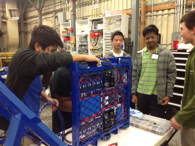 Students and EJ working on the robot