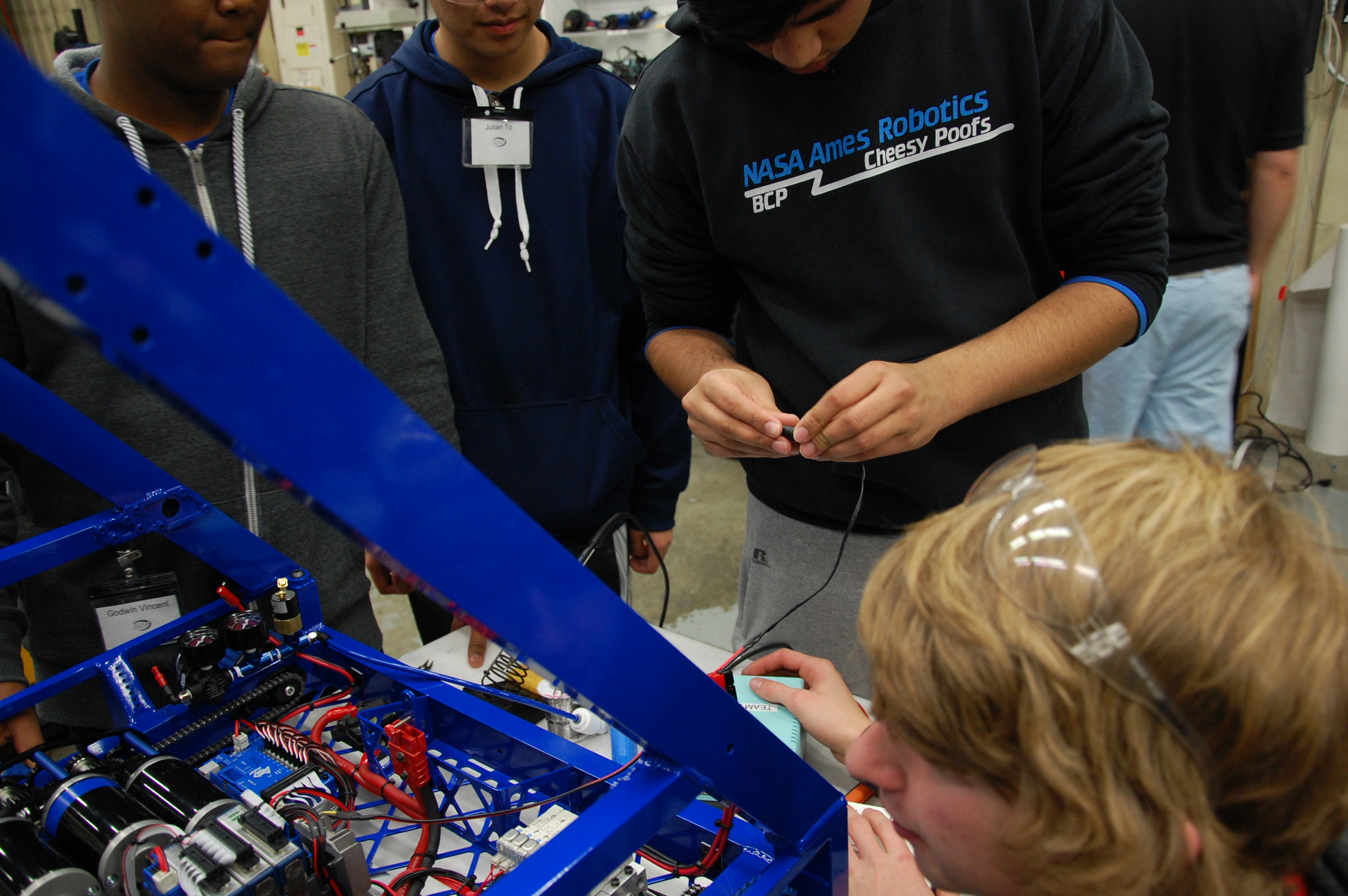 Students wiring the practice robot