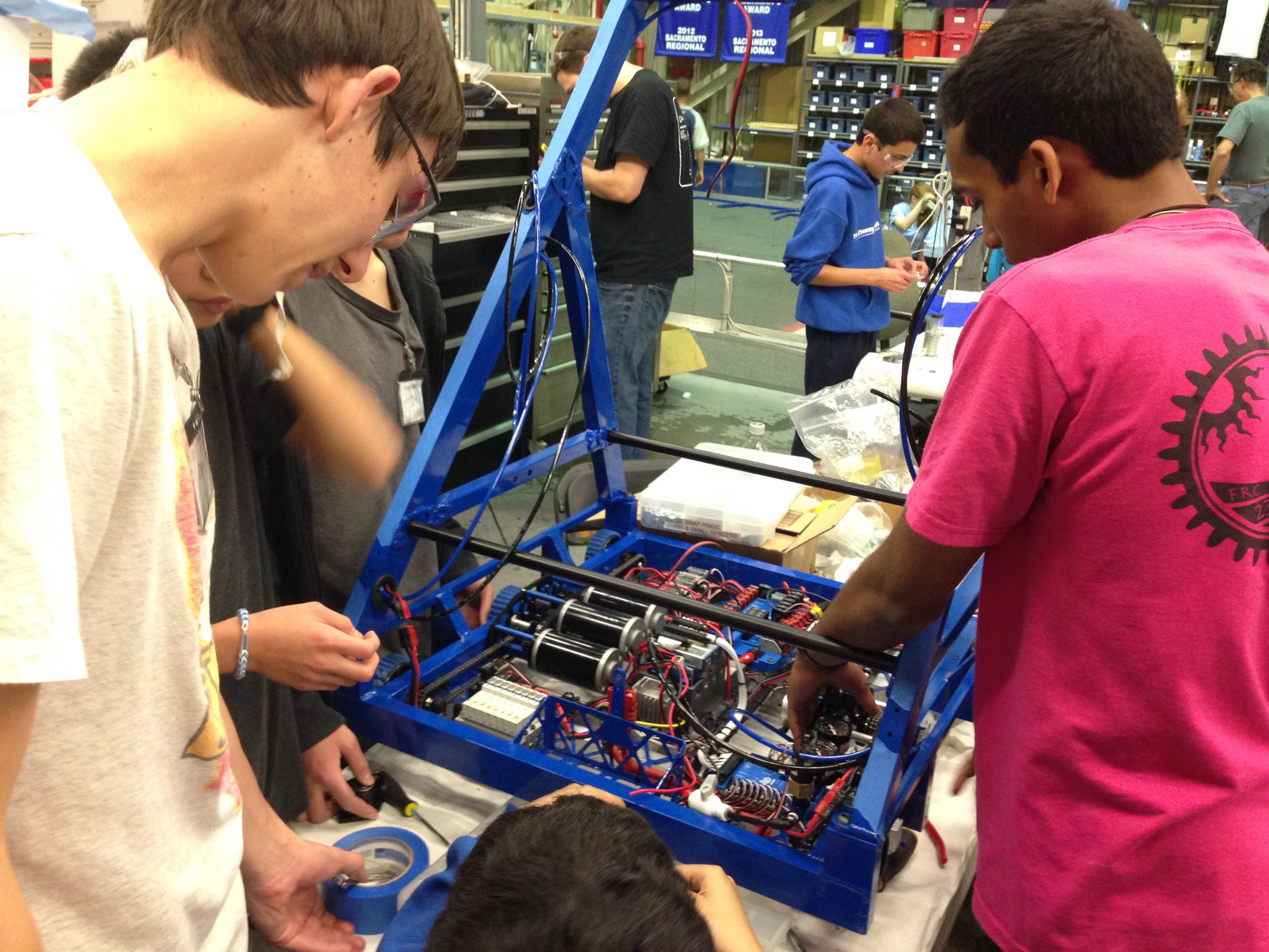 Students work on wiring the practice robot