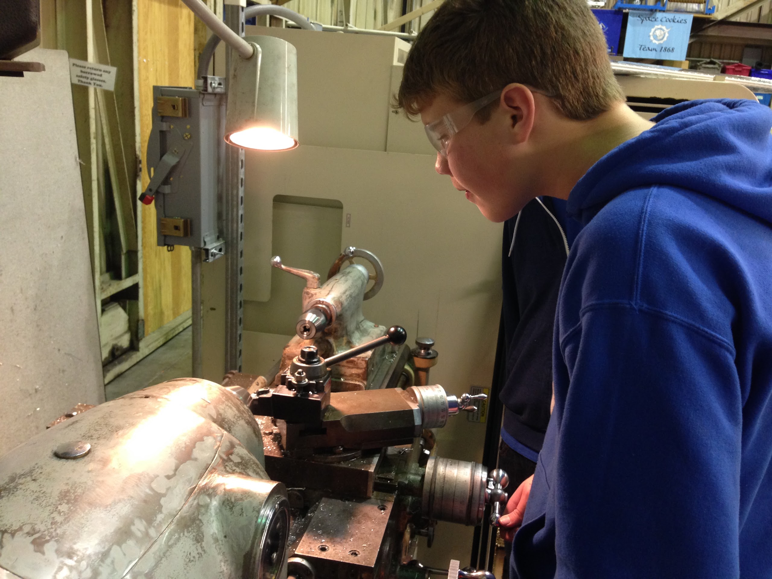 Students working on the lathe to machine parts for the control board