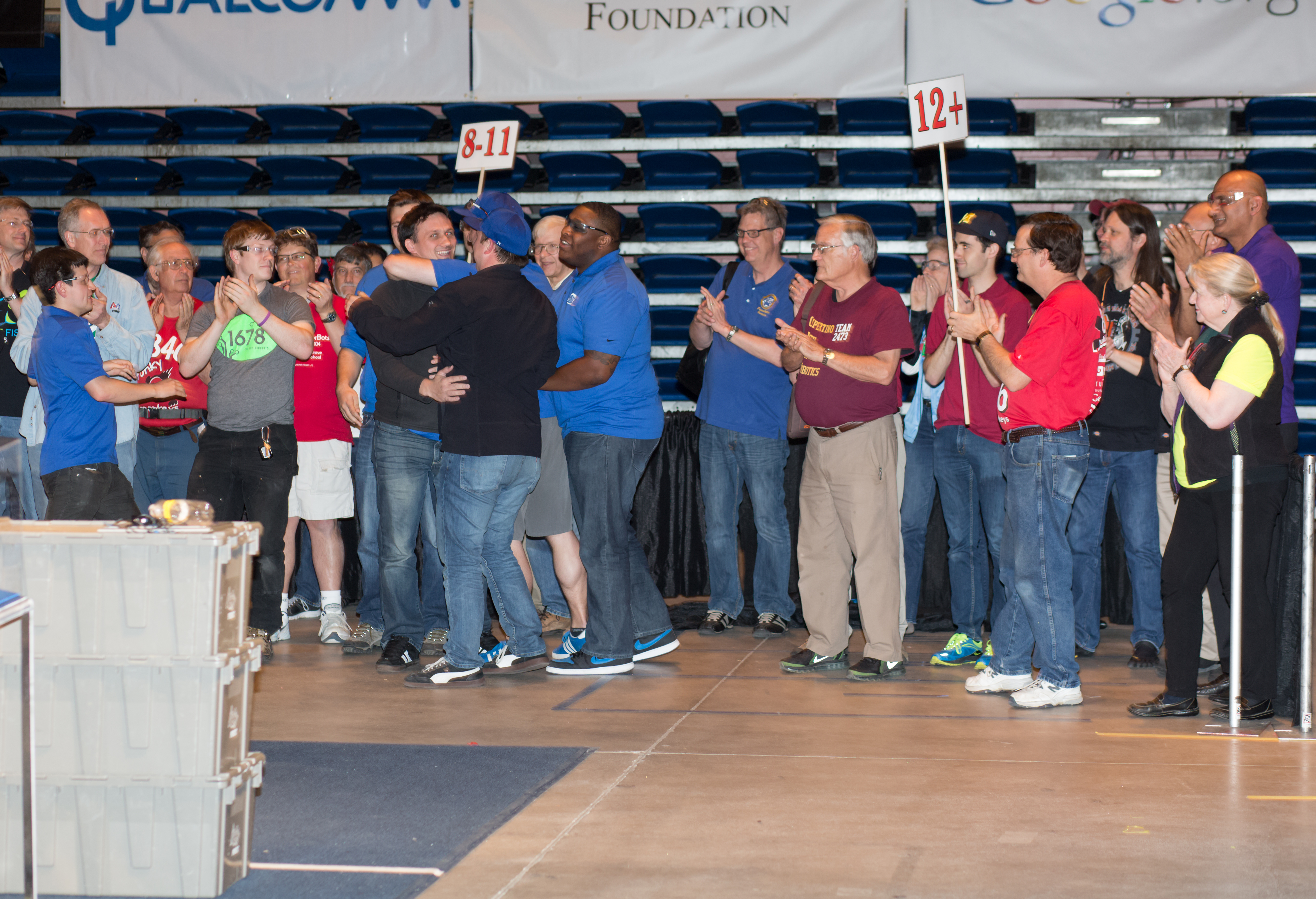 The other mentors congratulating Travis as he won