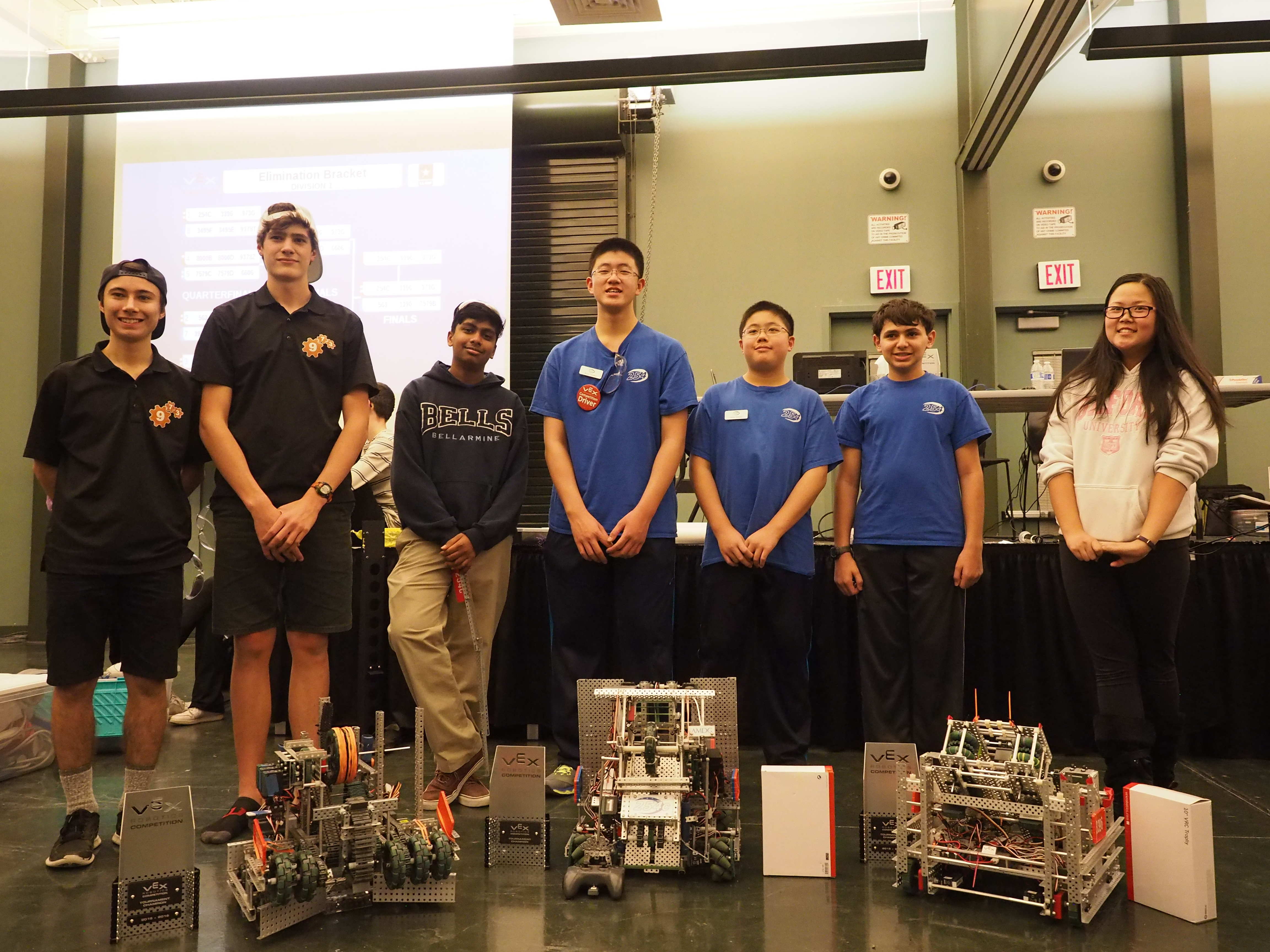Team 254C poses with their robot, trophy, and alliance partners.